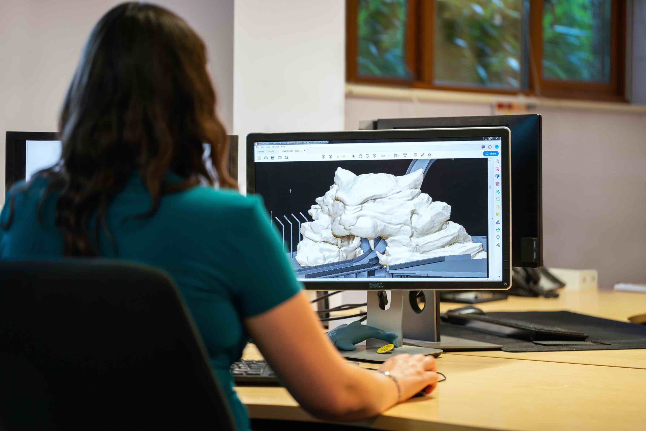 Young software engineer at work in front of her computer