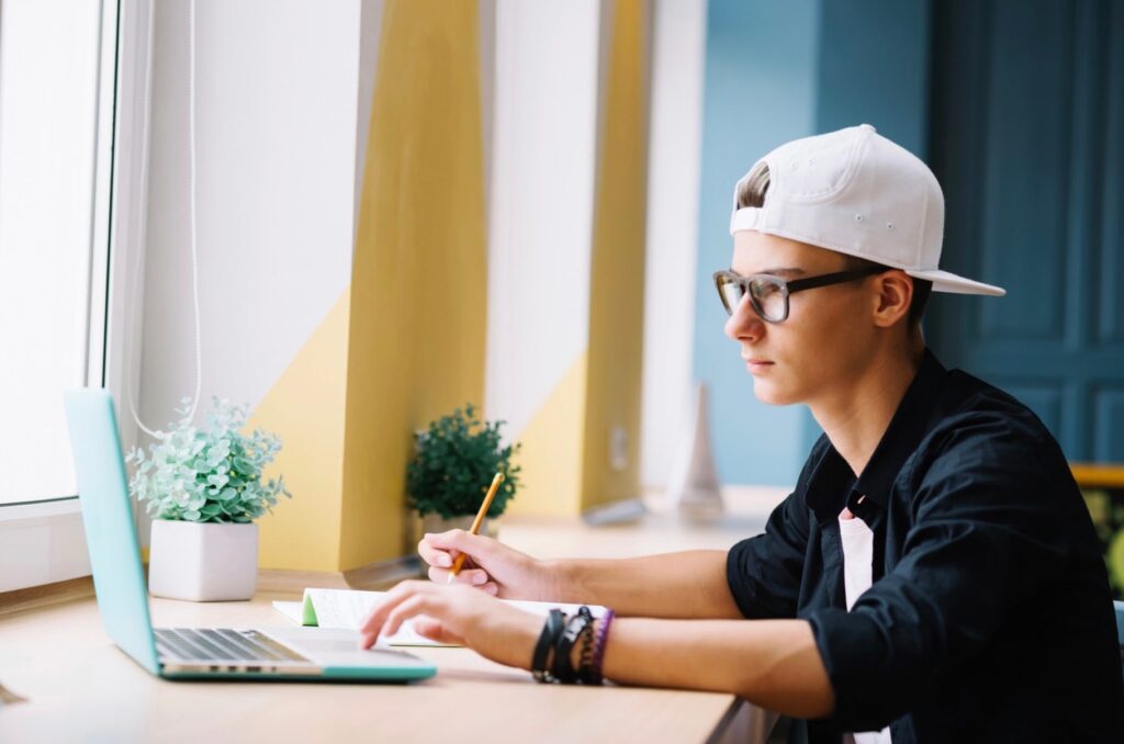 Youngster with laptop in classroom