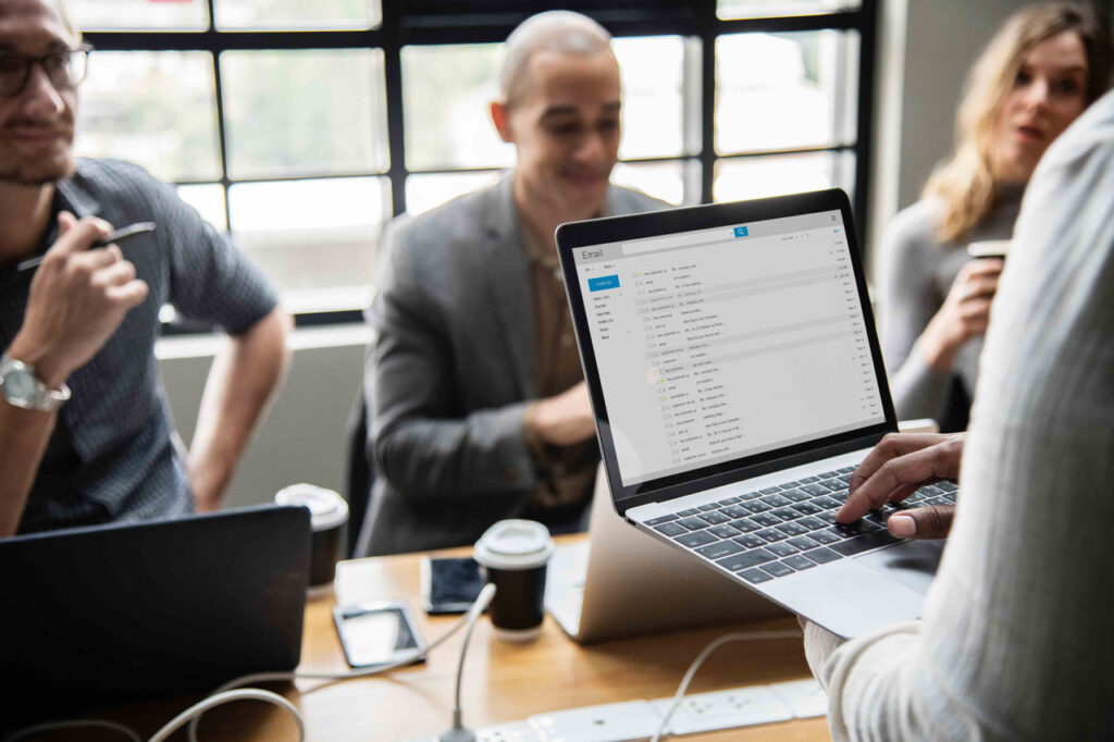 Businessman about to open a reference letter on his laptop