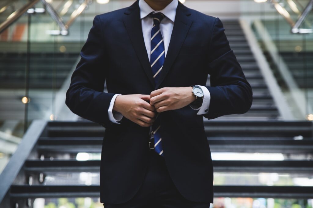 Close up of business man buttoning his suit