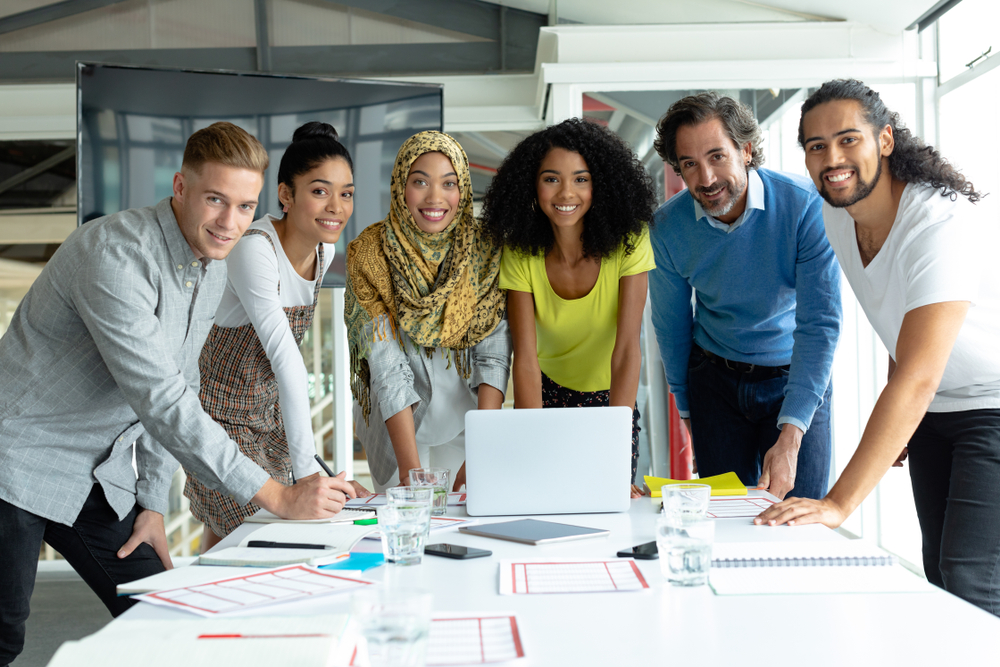 Front,View,Of,Diverse,Business,People,Looking,At,Camera,While