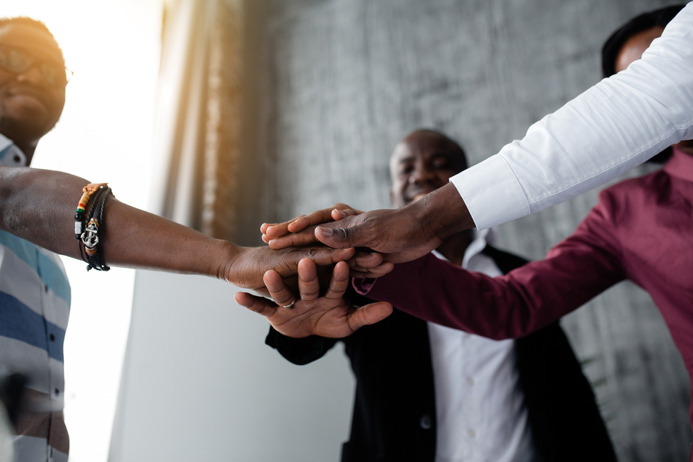 Bottom,View,Of,Black,Colleagues,Who,Joined,Hands,For,Hard