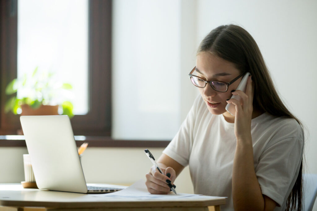 Female virtual assistant consulting client over phone