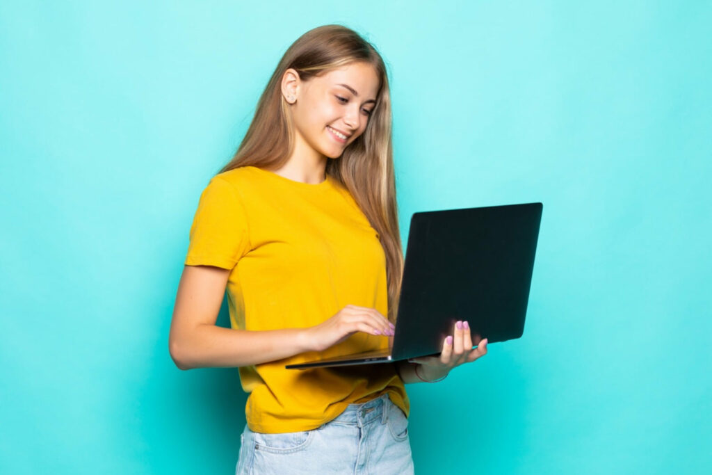 Young female job applicant preparing her resume on a laptop