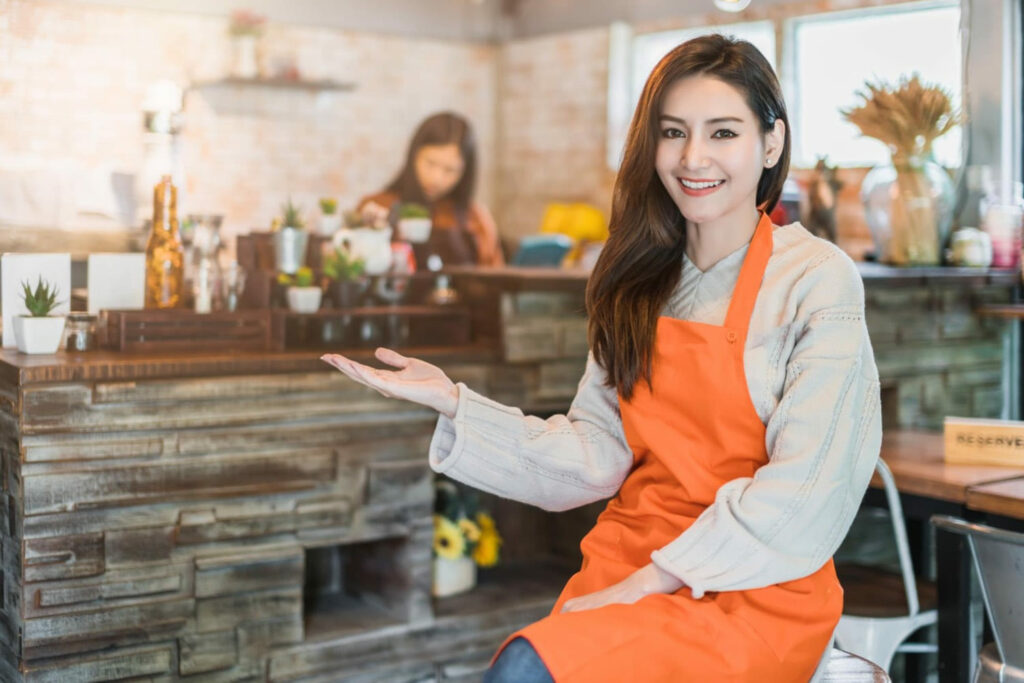 young smiling girl sitting in front of a food service