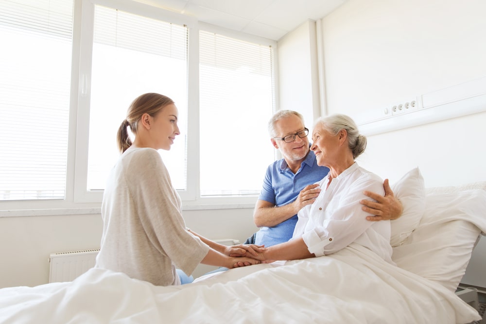 young woman visiting grandma in hospital