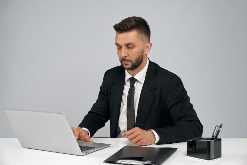 male job applicant typing on laptop