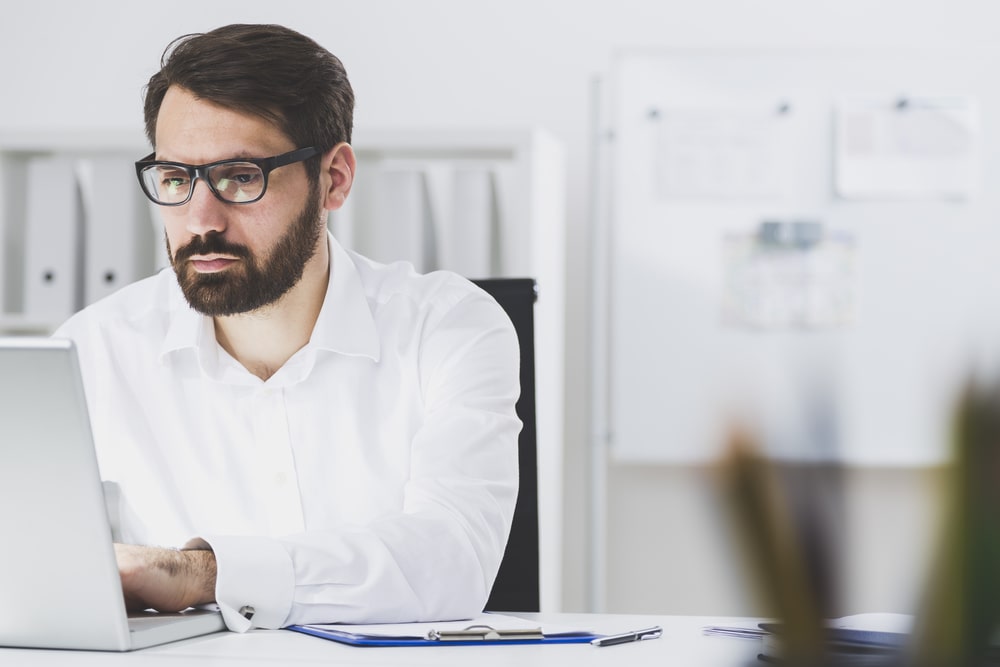 Business man is sitting in front of his laptop