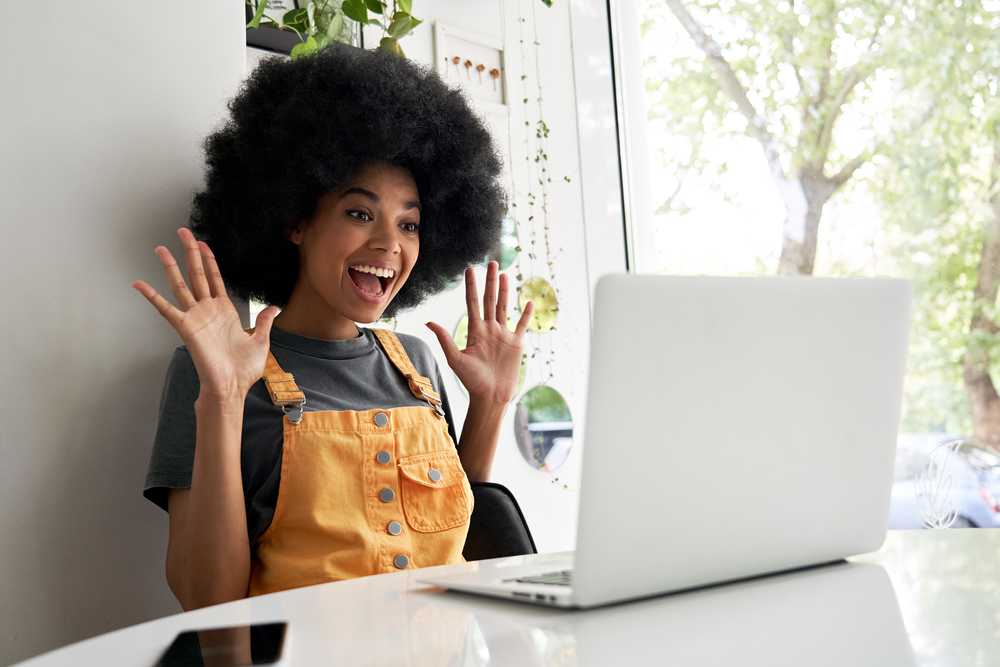 person at laptop excited and happy