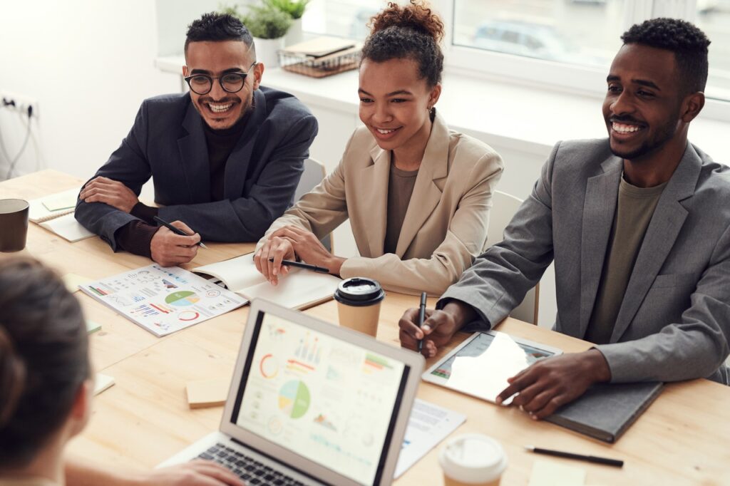 diverse employees sitting at table