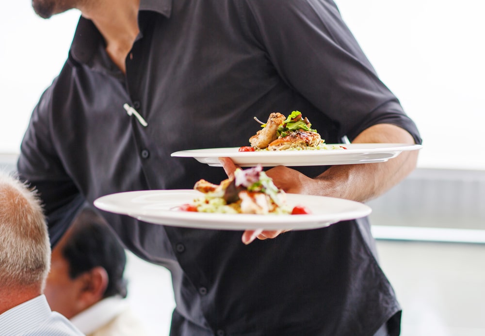 Restaurant server at work providing guests with a high-class dining experience and quality service