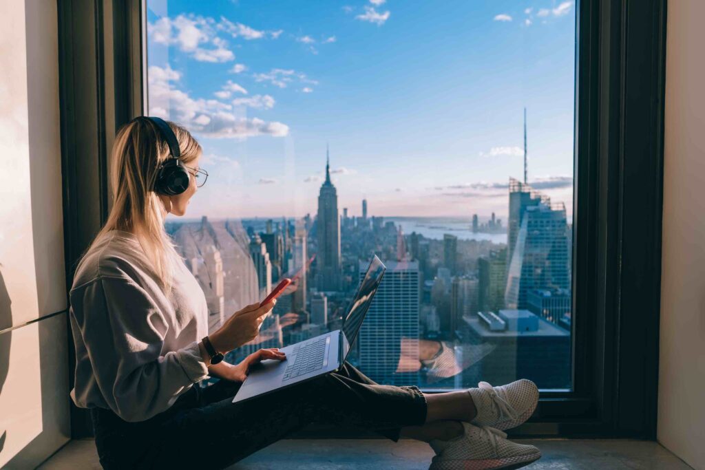 Young woman, Working in New York, Working in hotel, With Laptop, Home Office, Wearing headphones, On the phone