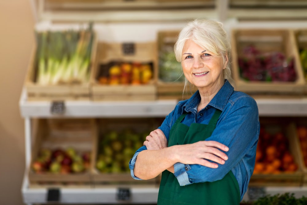 an old woman with vegetable stall