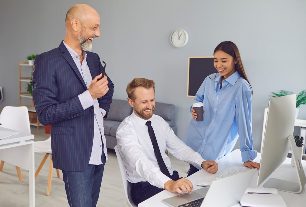 employees laugh in a positive work environment