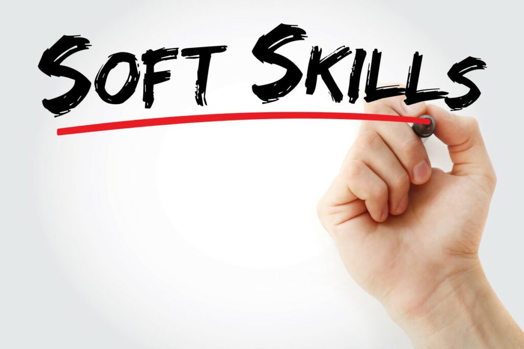 Soft Skills spelled out in black letters, underlined with a red line that is being drawn by a hand