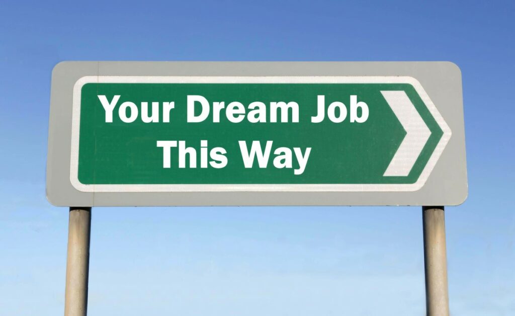 Green sign with white letters spelling Your Dream Job This Way