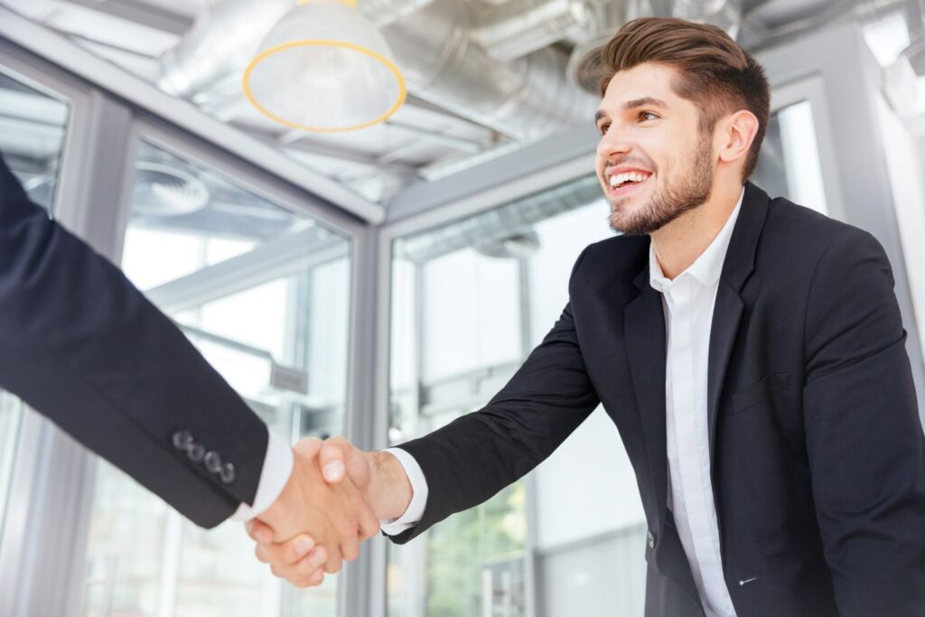 two guys shaking hands after a job interview