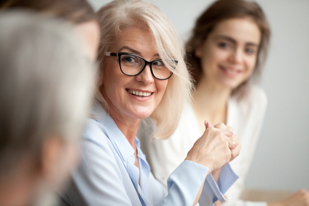 smiling older business woman with glasses