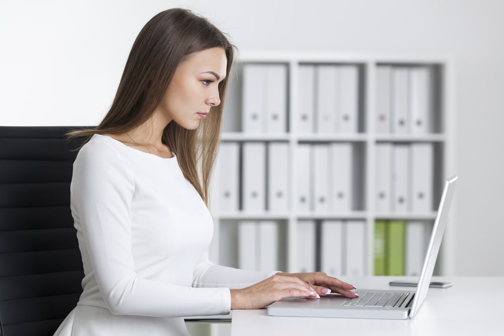 woman looks at her laptop