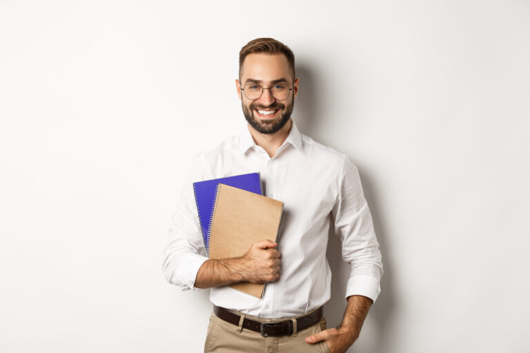 Young business manager smiling and holding files