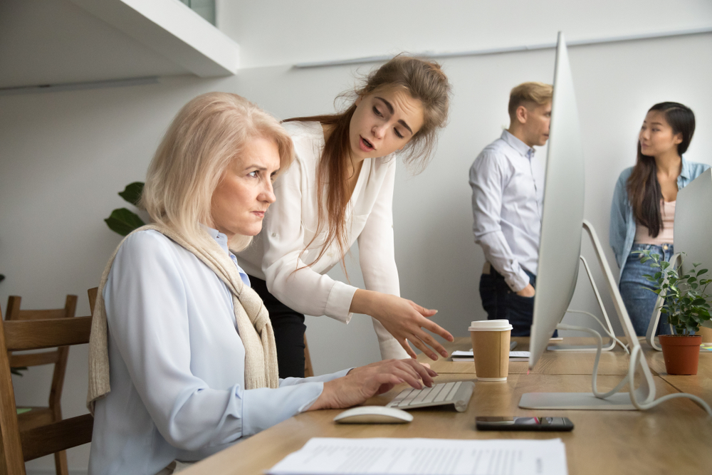 young woman correcting senior woman