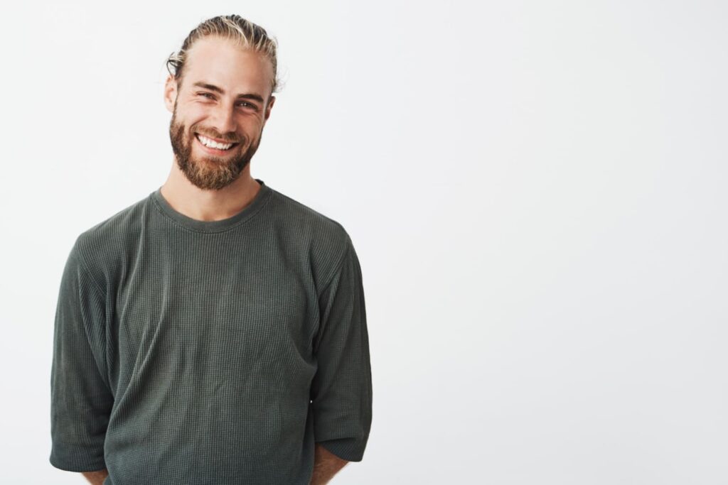 smiling young professional standing in front of a wall