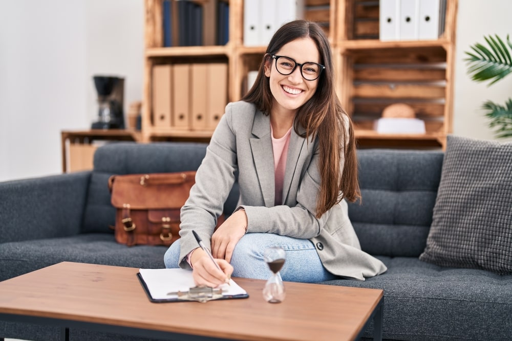 young female psychologist filling out documents